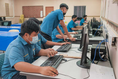 Muadzam Shah, Malaysia - Mei 6th, 2021: Furniture Production Operation students wearing face mask with teacher working in CAD Lab.のeditorial素材