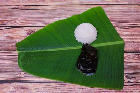 Cooked rice and  chicken cooked in soy sauce or Ayam Masak Kicap  on banana leafの写真素材