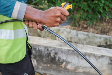 Muadzam Shah, Malaysia- September 1st, 2021 : Worker from telecomunication internet provider company working on implementation of fiber optic cables in Muadzam Shah .のeditorial素材