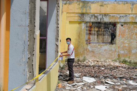 Muadzam Shah, Malaysia- September 4st, 2021 :Contractor took measurements of the roofing work in the process of repairing the building due to fireのeditorial素材