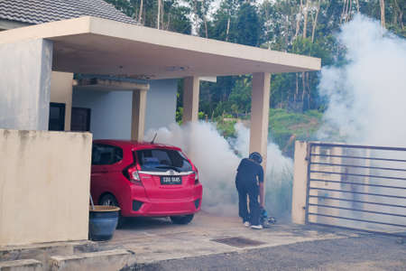 Malaysia - September 20th, 2021: Worker fogging residential area with insecticides to kill aedesのeditorial素材