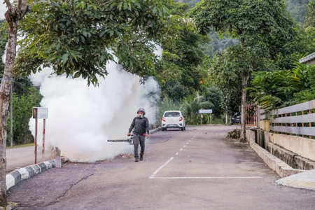 Malaysia - September 20th, 2021: Worker fogging residential area with insecticides to kill aedesのeditorial素材