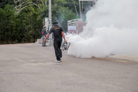 Malaysia - September 20th, 2021: Worker fogging residential area with insecticides to kill aedes
