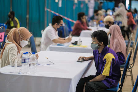 Muadzam Shah, Malaysia - September 28th, 2021: Indoor view of people wearing mask waiting queue for coronavirus covid-19 vaccinationのeditorial素材