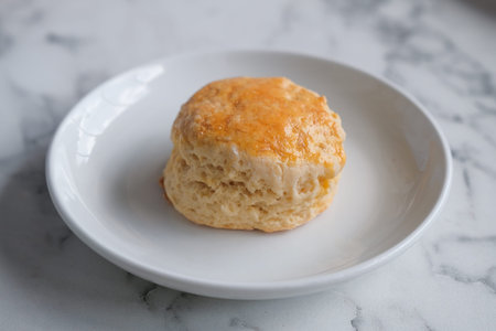 Scone with strawberry jam and clotted cream.の写真素材