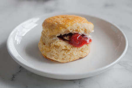 Scone with strawberry jam and clotted cream.の写真素材
