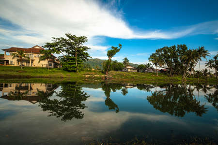 Coconut tree reflect shadow on surface of river beautiful sky in Beserah, Malaysia .の写真素材