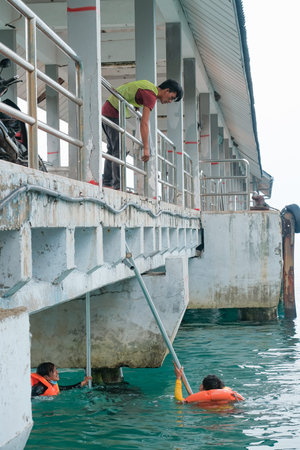 Tioman, Malaysia- 20 April 2022 : Construction worker is assembly scaffolding above sea water for...