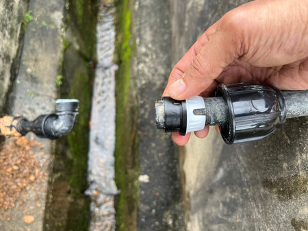 Man's hand holding a water pipe.