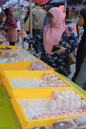 Kuantan  , Malaysia - FEBRUARI 2ND, 2023 : Muslim vendors selling halal foods from roadside stall at...