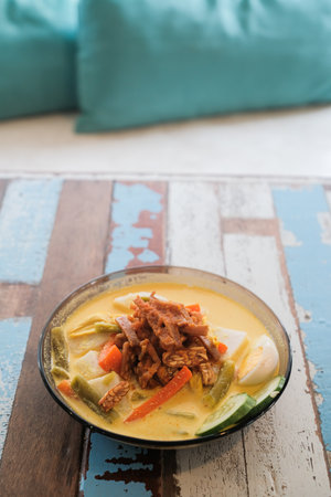 Lontong-Traditional Malaysian and Indonesian food on wooden tableの写真素材