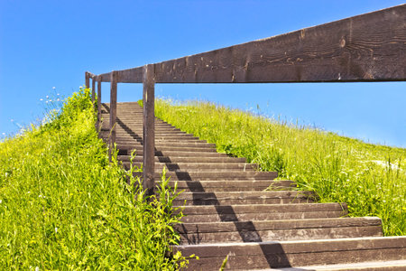 Stairs to blue sky on green hill. Abstract natural backgrounds. Horizontal image
