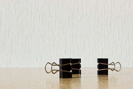 Binder clips figure on wooden table. Conceptual image: office chainの写真素材