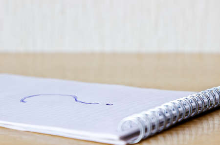 Notebook with question on tableの写真素材