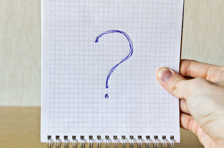 Notebook with question in handの写真素材