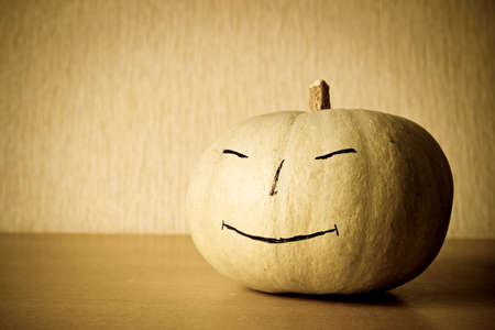 Music lover pumpkin with smile and headphones. Vintage image with dark vignetteの写真素材