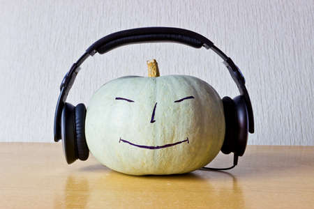 Music lover pumpkin with smile and headphonesの写真素材