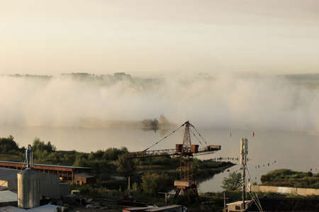 Fog over river in the morningの写真素材