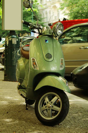 Green scooter Vespa parked at the street in Prague, Czech Republicのeditorial素材