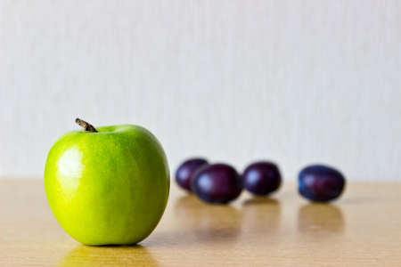 Fresh ripe fruits: apple and prunes. Focus on appleの写真素材