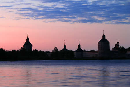 Russian orthodox monastery on the lake shore at sunriseの写真素材