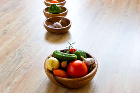 Fresh vegetables in wooden bowls in row. Focus on foreground. Horizontal imageの写真素材