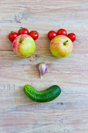 Funny smiling face. Conceptual image with vegetables. Vertical imageの写真素材