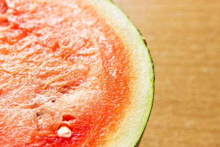 Half of water melon on wooden table, top view close upの写真素材