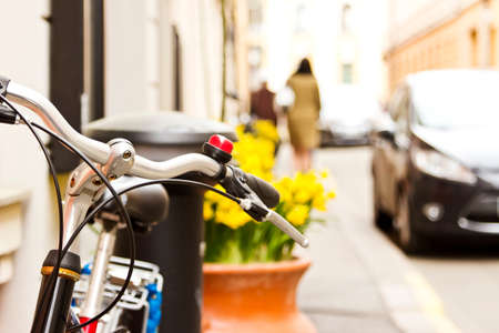 Bicycle near the wall at the street. Image with bokeh town backgroundの写真素材