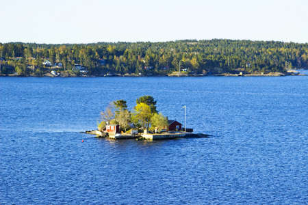 Colorful landscape of Baltic sea with small island near coastline of Swedenの写真素材