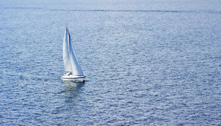 Sailing ship yachts with white sails in the seaの写真素材