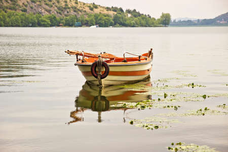 Lonely wooden boat on the lakeの写真素材
