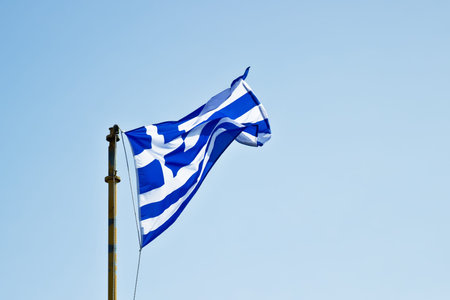 Greek flag at blue skyの写真素材
