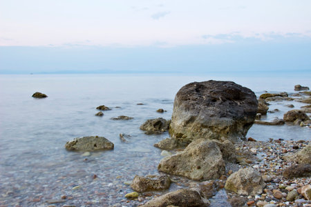 Tranquility sunset landscape with stones in seaの写真素材