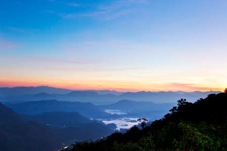 Beautiful mountain landscape in fog at sunrise. View from Adam peak in Sri Lanka, Ceylonの写真素材