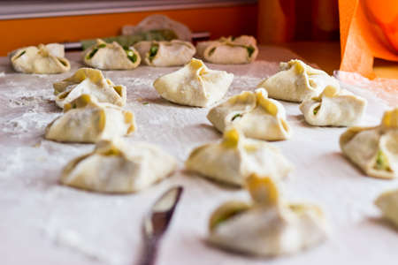 Cooking homemade puff pastry cakes with onion and egg. Focus on backgroundの写真素材