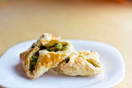 Fresh baked homemade puff pastry cakes with onion and eggの写真素材