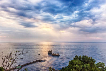 Beautiful cloudy sunrise seascape. HDR image from three photosの写真素材