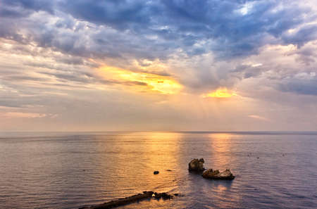 Beautiful cloudy sunrise seascape. HDR image from three photosの写真素材