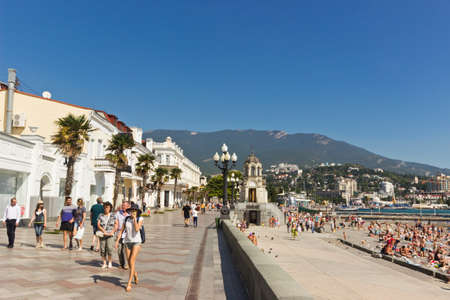 tourists walking on seaside embankment in Yalta city. Yalta is resort city on the north coast of the Black Sea on the Crimean peninsulaのeditorial素材