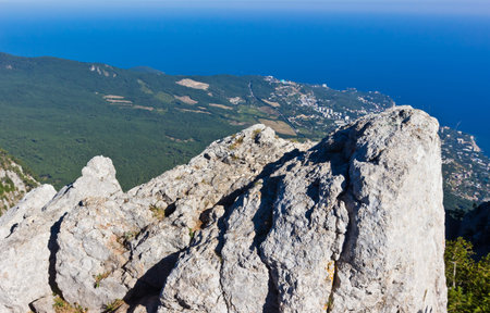 High rocks Ai-Petri of Crimean mountains. Black sea coast and blue sky with clouds. Russia