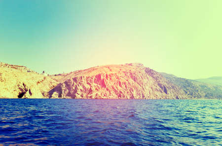 Black Sea rocky coastline seascape near Balaklava. Crimea, Russia. Image toned with vintage filterの写真素材