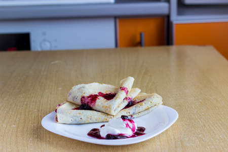 Pancakes with sour cream and berry jamの写真素材