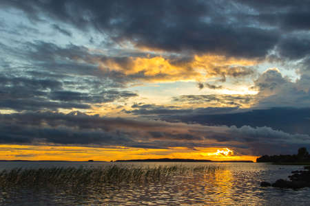 Beautiful tranquil summer sunset on the Onega lake, Karelia, Russiaの写真素材