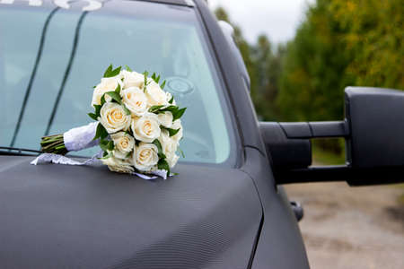 Wedding bouquet of roses on black pick upの写真素材