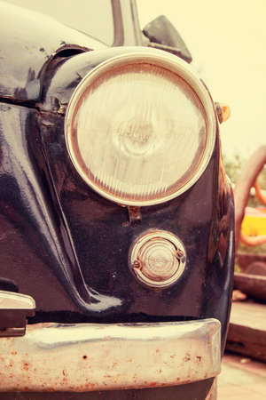 Retro headlight of vintage car. Image with vintage filter. Selective focusの写真素材
