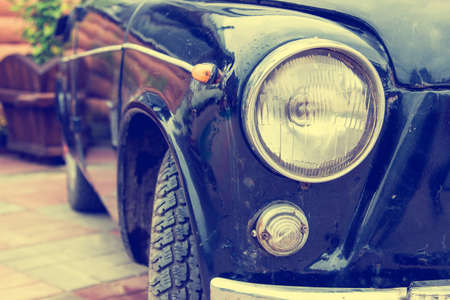 Retro headlight of vintage car. Image with vintage filter. Selective focusの写真素材