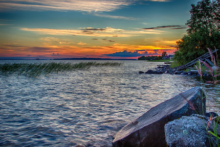 Beautiful tranquil summer sunset on the Onega lake, Karelia, Russia. High contrast hdr image made from three photosの写真素材