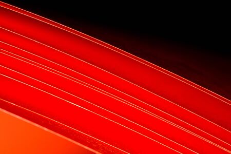The red A4 paper illuminated with LED lights as background abstractの写真素材