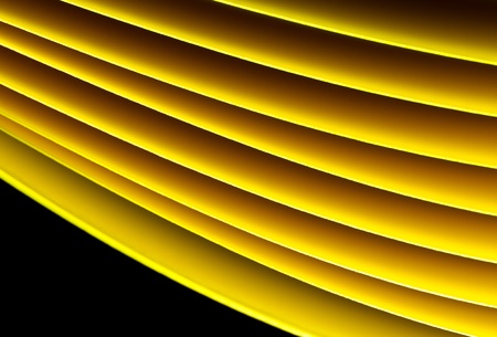 Yellow A4 papers under illumination by LED lights shine against the black backgroundの写真素材